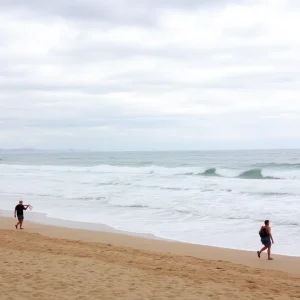 Scenic view of Orange County beach with elevated surf conditions.
